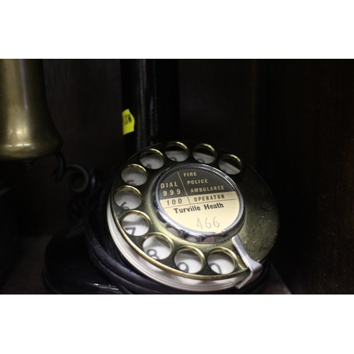 120 - A rotary candlestick black and brass mounted telephone and a slate mantel clock with enamelled dial ... 