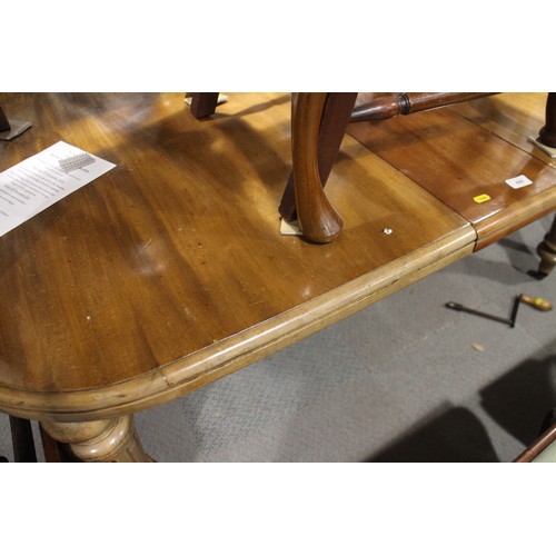 496 - A late 19th century walnut extending dining table with three extra leaves, on turned fluted castored... 