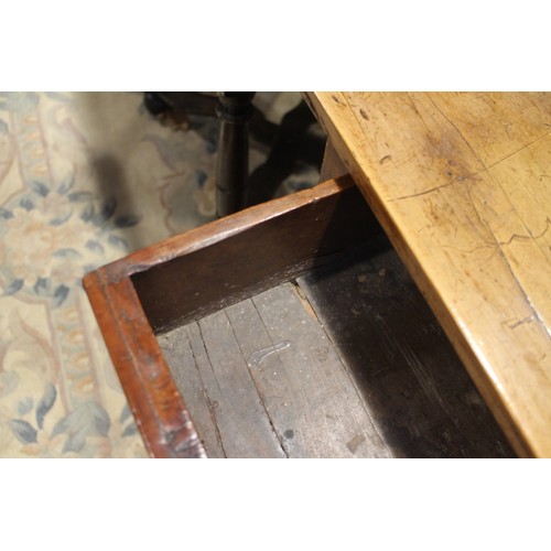 430 - An early 18th century yew side table, fitted one drawer with brass shaped drop handle, on bobbin tur... 