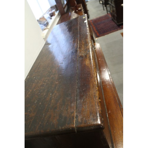 476 - A 17th century oak boarded coffer, on panel end supports, 51