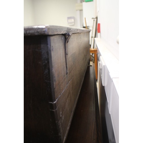 476 - A 17th century oak boarded coffer, on panel end supports, 51