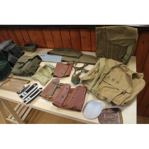 202 - A Commando chain saw, a quantity of canvas bags, pouches, hats and other items, contained in a tin t... 