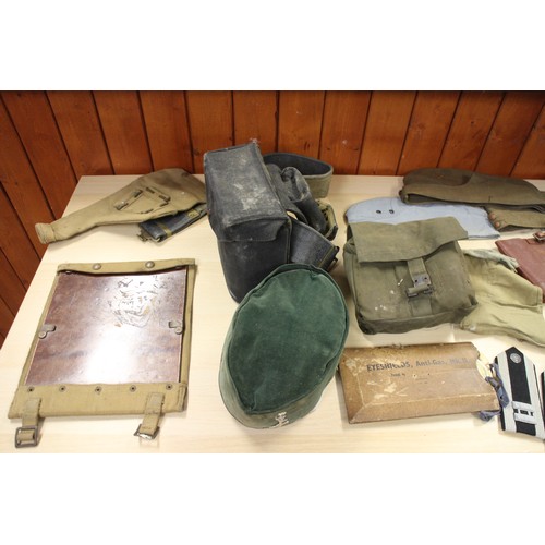 202 - A Commando chain saw, a quantity of canvas bags, pouches, hats and other items, contained in a tin t... 