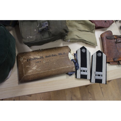 202 - A Commando chain saw, a quantity of canvas bags, pouches, hats and other items, contained in a tin t... 