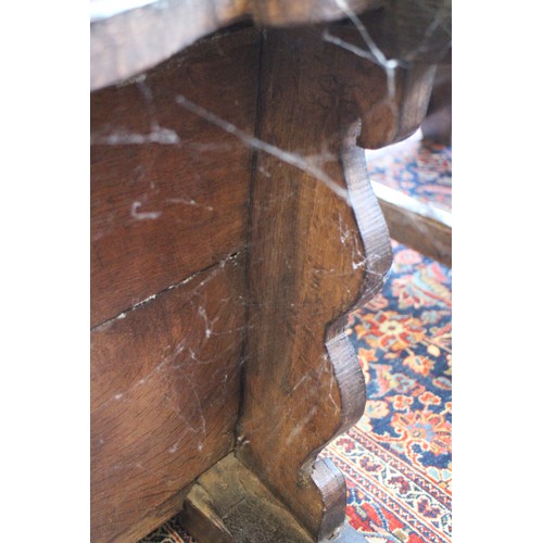 459 - A 17th century carved oak wainscot armchair with scroll panel back, on turned and stretchered suppor... 