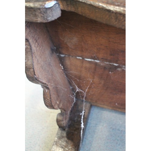 459 - A 17th century carved oak wainscot armchair with scroll panel back, on turned and stretchered suppor... 