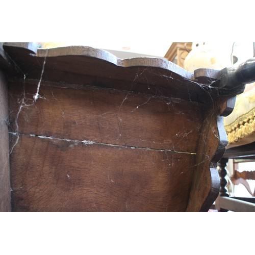 459 - A 17th century carved oak wainscot armchair with scroll panel back, on turned and stretchered suppor... 