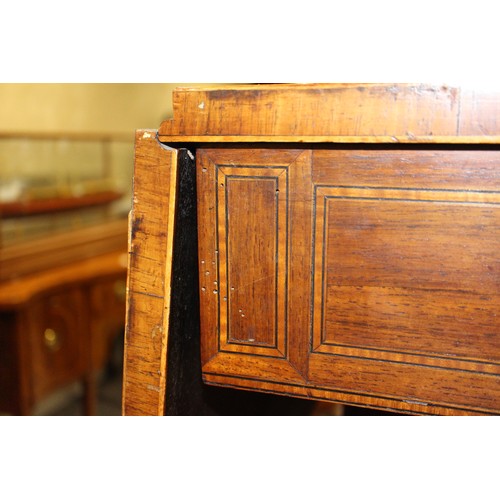 446 - A Regency rosewood and mahogany banded sofa table, fitted two drawers with brass star handles, on sp... 