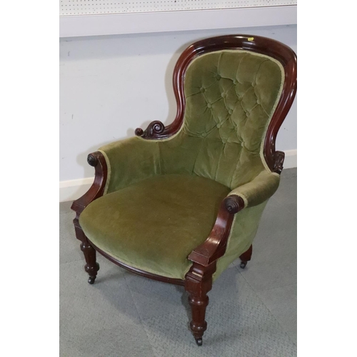 537 - A 19th century mahogany showframe armchair, button upholstered in a green velvet, on turned and cast... 