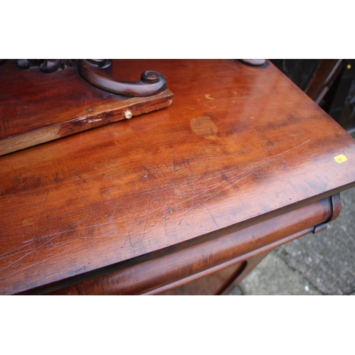 539 - A Victorian mahogany chiffonier with carved ledge back over two drawers and cupboards, on block base... 