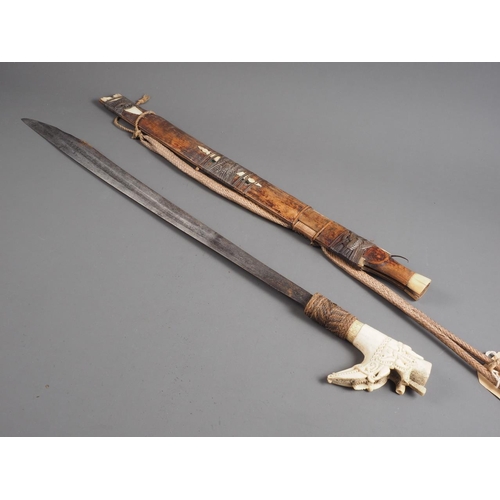 150 - An Indonesian Dayak Mandau sword with paktong? pellets inlaid on the blade and carved bone handle/po... 