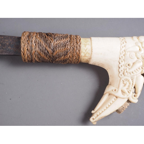 150 - An Indonesian Dayak Mandau sword with paktong? pellets inlaid on the blade and carved bone handle/po... 