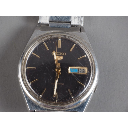 311 - A quantity of mostly gentleman's fashion watches, including a Seiko 5 Automatic, a gold plated half ... 