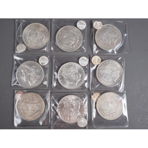 374 - Nine late 19th century and later American silver one dollar coins