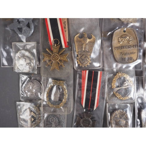 387 - A quantity of Nazi medals and badges, including a Kriegsmarine Destroyer Navy badge, a War Merit Cro... 