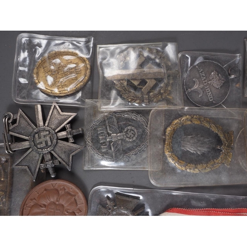 387 - A quantity of Nazi medals and badges, including a Kriegsmarine Destroyer Navy badge, a War Merit Cro... 