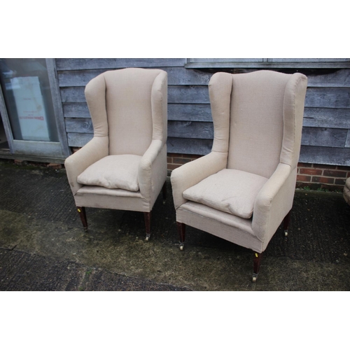 482 - Pair of wing arm chairs, upholstered in a sack cloth, on square taper castored supports