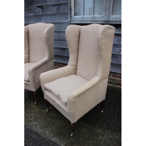 482 - Pair of wing arm chairs, upholstered in a sack cloth, on square taper castored supports