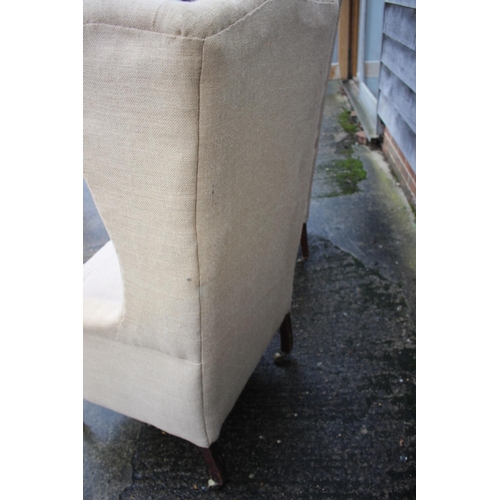 482 - Pair of wing arm chairs, upholstered in a sack cloth, on square taper castored supports