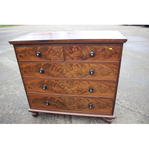 483 - A Victorian flame figured mahogany chest of four long graduated drawers with turned ebony and knobs ... 