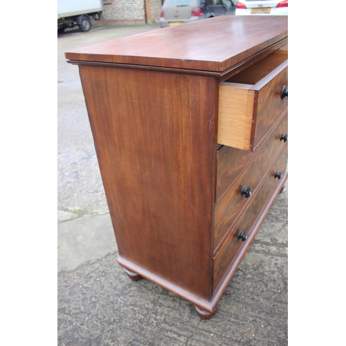 483 - A Victorian flame figured mahogany chest of four long graduated drawers with turned ebony and knobs ... 