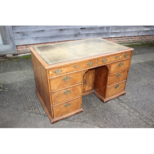 488 - A 19th century figured walnut and banded kneehole desk with tooled lined top, fitted two wide drawer... 