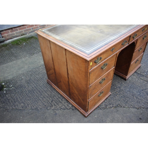 488 - A 19th century figured walnut and banded kneehole desk with tooled lined top, fitted two wide drawer... 