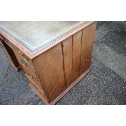 488 - A 19th century figured walnut and banded kneehole desk with tooled lined top, fitted two wide drawer... 