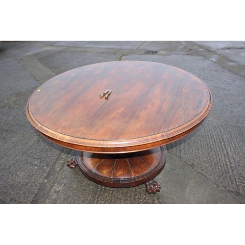 497 - An early 19th century rosewood circular tilt top dining table, on faceted bulbous column and lion pa... 