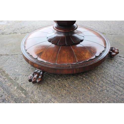 497 - An early 19th century rosewood circular tilt top dining table, on faceted bulbous column and lion pa... 