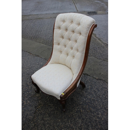 504 - A mid 19th century rosewood showframe low seat nursing chair, button upholstered in a figured brocad... 