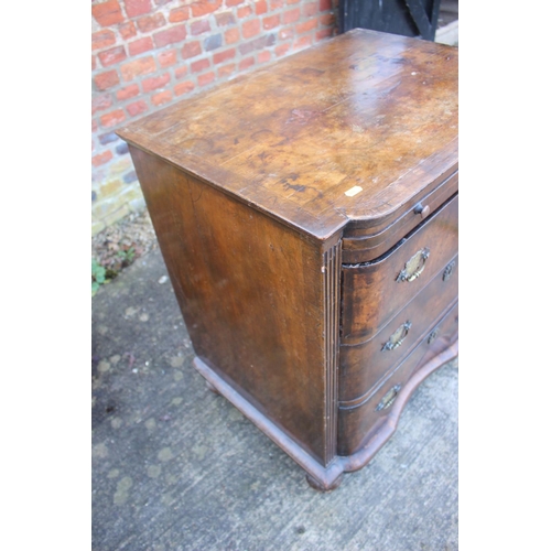 516 - A bachelor's early Georgian figured walnut and feather banded break bowfront chest of three long dra... 