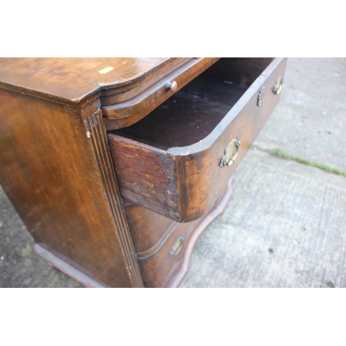 516 - A bachelor's early Georgian figured walnut and feather banded break bowfront chest of three long dra... 