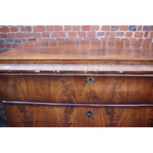 517 - A 19th century Continental figured mahogany commode chest of three drawers with shaped fronts, on br... 