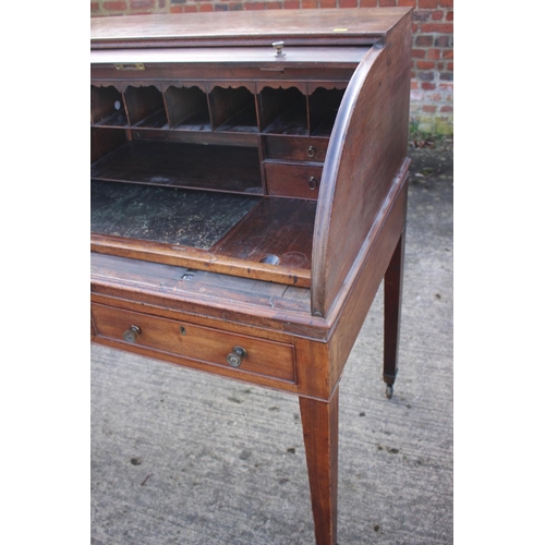 525 - A 19th century mahogany roll top desk with pull-out writing surface, drawers and pigeonholes over tw... 