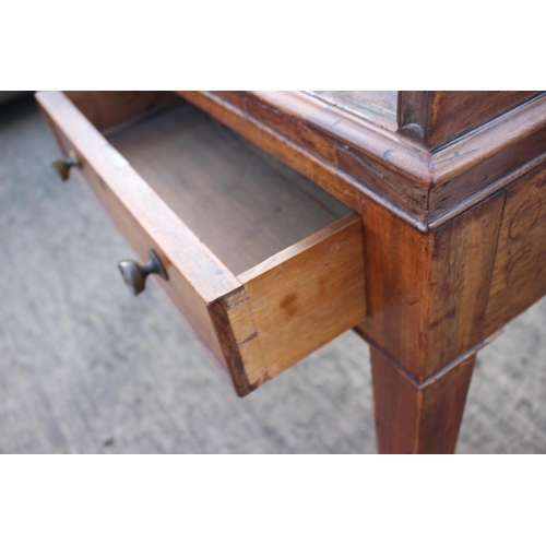 525 - A 19th century mahogany roll top desk with pull-out writing surface, drawers and pigeonholes over tw... 