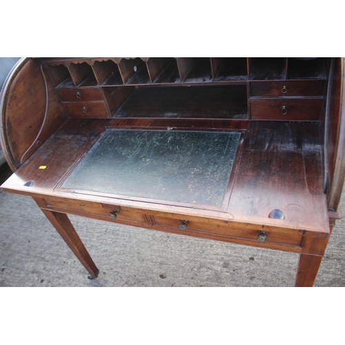 525 - A 19th century mahogany roll top desk with pull-out writing surface, drawers and pigeonholes over tw... 