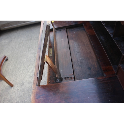 525 - A 19th century mahogany roll top desk with pull-out writing surface, drawers and pigeonholes over tw... 