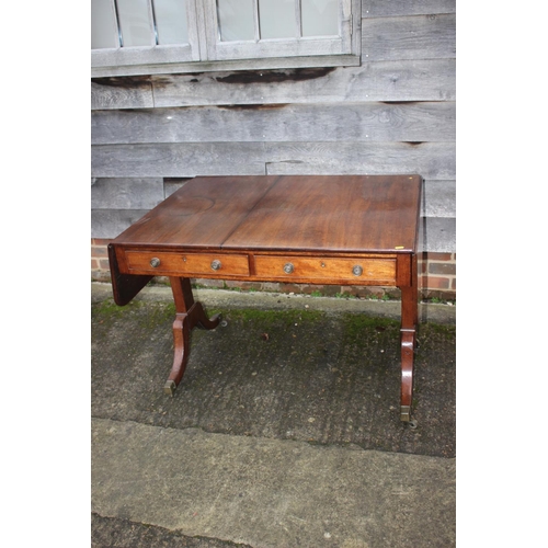 528 - A 19th century mahogany sofa table, fitted two drawers with brass knobs, on splay supports and brass... 