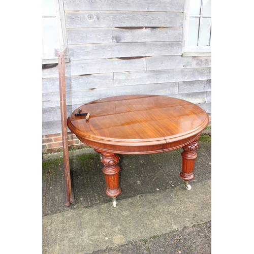 530 - A late Victorian mahogany extending dining table with two extra leaves, on turned and carved castore... 