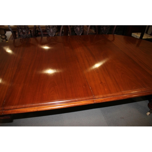 530 - A late Victorian mahogany extending dining table with two extra leaves, on turned and carved castore... 