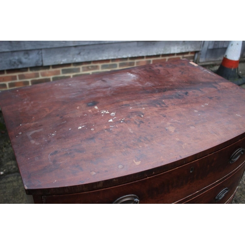 533 - An early 19th century mahogany bowfront chest of three graduated long drawers with oval brass handle... 