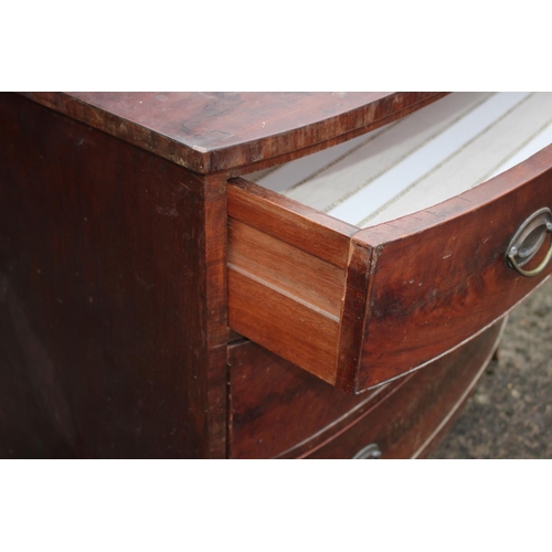 533 - An early 19th century mahogany bowfront chest of three graduated long drawers with oval brass handle... 