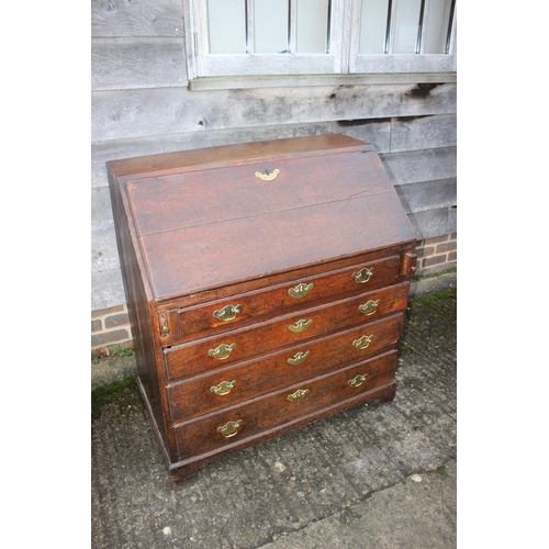 540 - An 18th century oak fall front bureau, the interior fitted drawers, pigeonholes and cupboard over fo... 