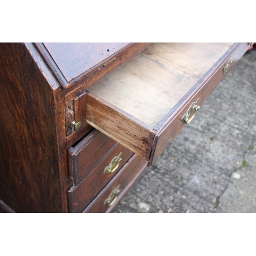 540 - An 18th century oak fall front bureau, the interior fitted drawers, pigeonholes and cupboard over fo... 