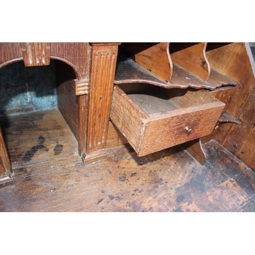 540 - An 18th century oak fall front bureau, the interior fitted drawers, pigeonholes and cupboard over fo... 