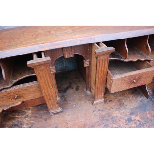 540 - An 18th century oak fall front bureau, the interior fitted drawers, pigeonholes and cupboard over fo... 