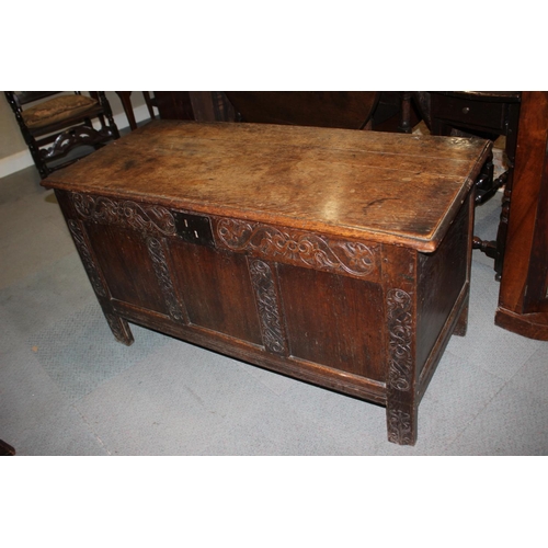 541 - An early 18th century carved oak triple panel front coffer with candle box, on stile supports, 49