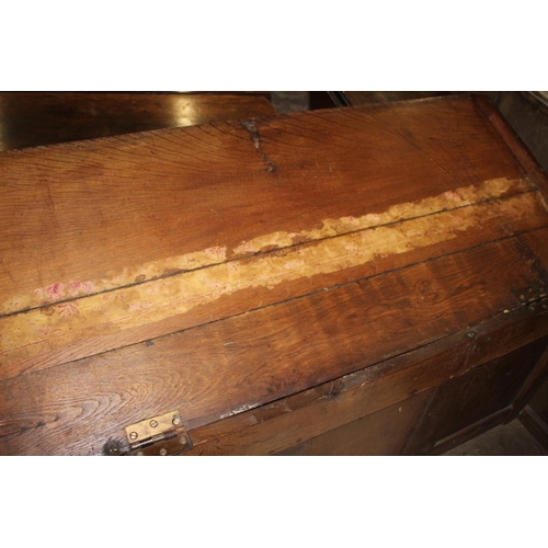 541 - An early 18th century carved oak triple panel front coffer with candle box, on stile supports, 49