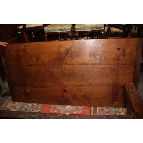 563 - An oak refectory table of early 17th century design with cleated plank top, on twin square baluster ... 